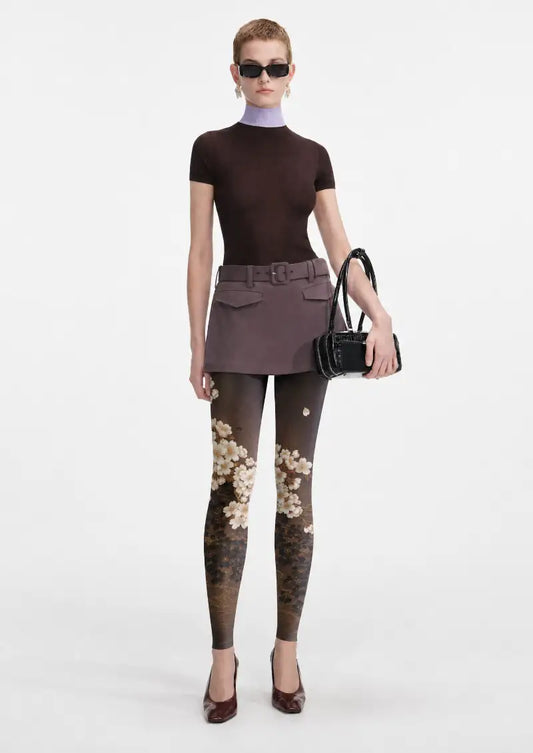 Model wearing Black Gold Sakura Floral Footless Tights in a styled outfit