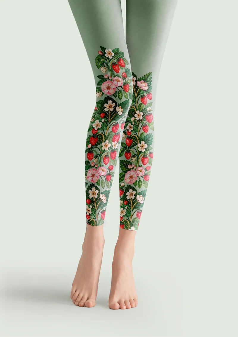 Green printed footless tights with red strawberries, pink flowers and leafy botanical motifs