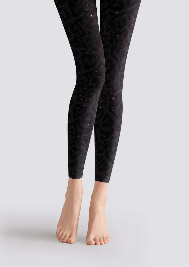 Black printed footless tights with subtle gray leopard markings and small star-like accents