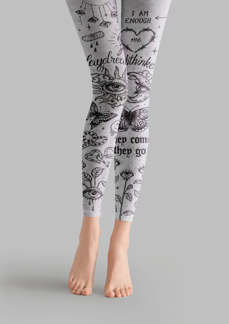 Gray printed footless tights with black tattoo-style eyes, butterflies, hearts and text