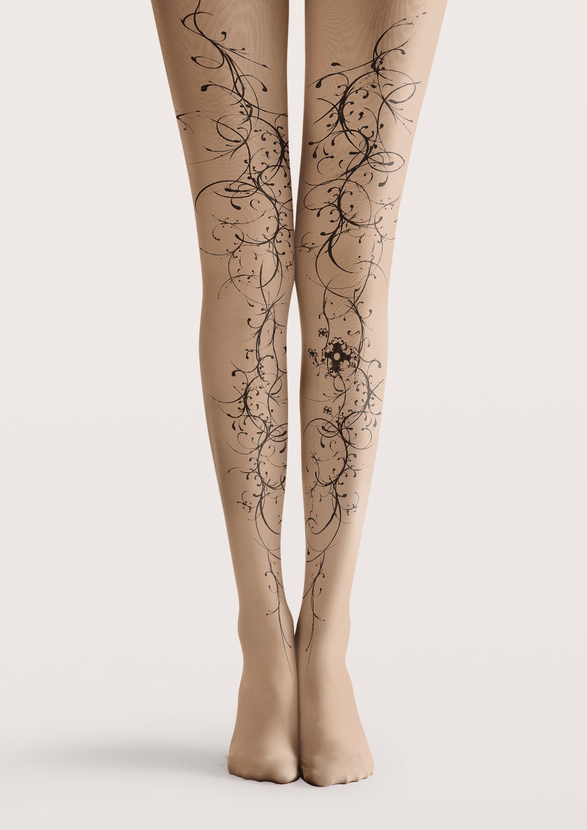 Beige printed tights with black curling vines, fine tendrils, and an ornamental flourish on one calf