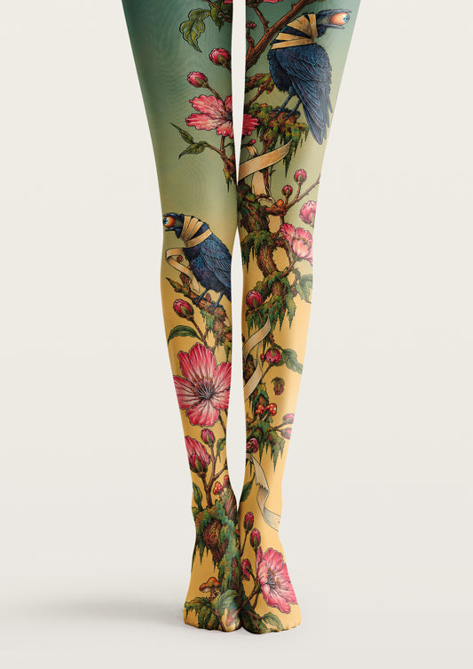 Yellow and green printed tights with pink flowers, leafy branches, and illustrated blue birds.