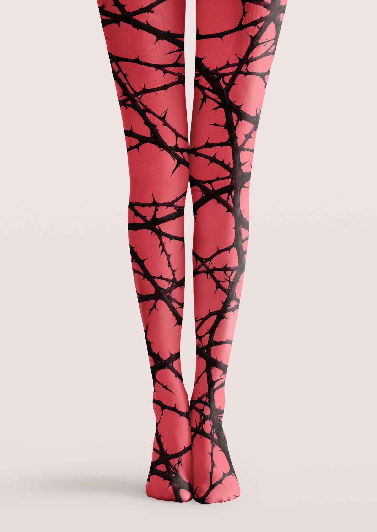 Pink printed tights with intersecting black thorn branches across both legs, ankles, and feet