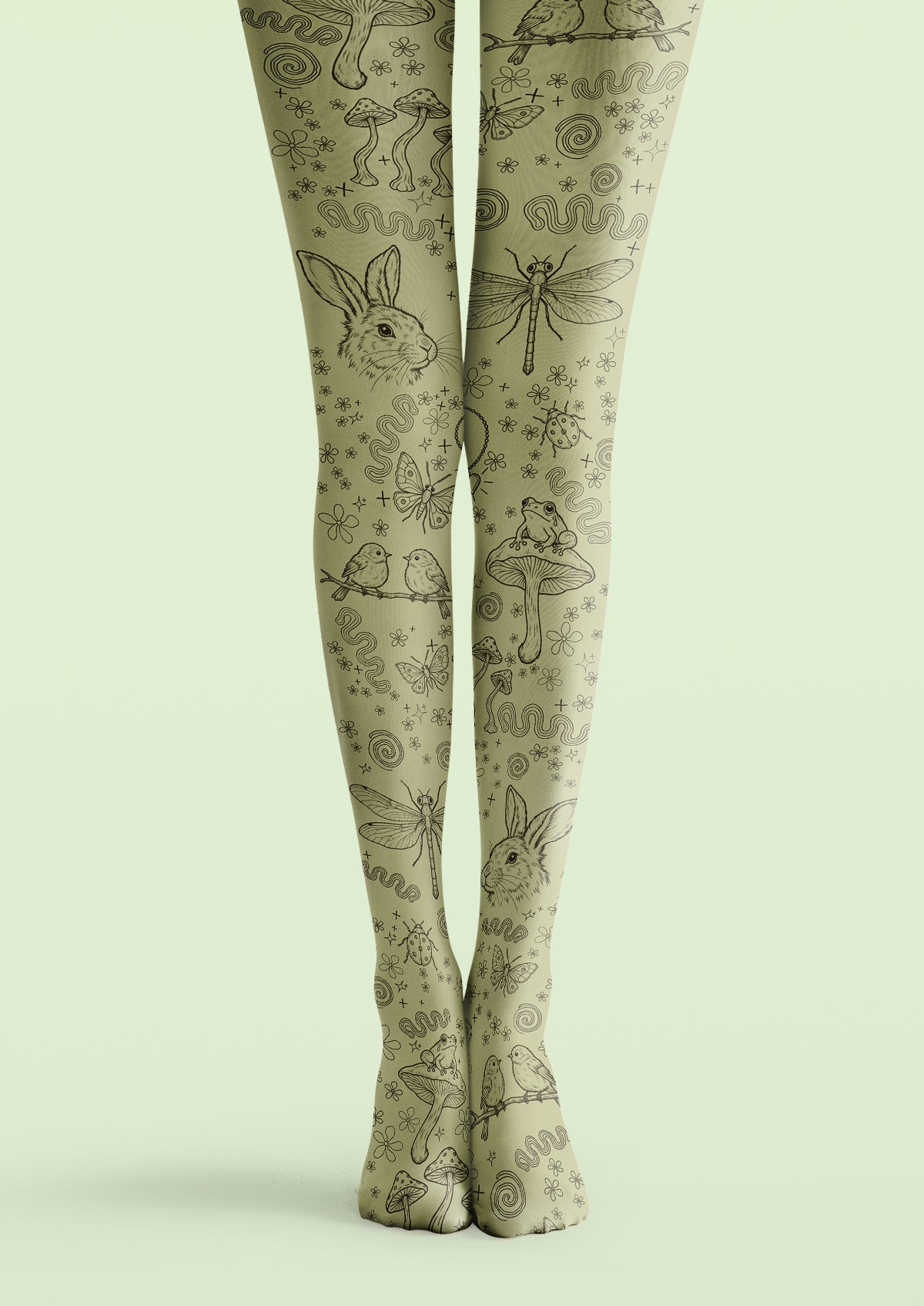 Green printed tights with black sketches of rabbits, mushrooms, frogs, birds, insects, small flowers, and spirals