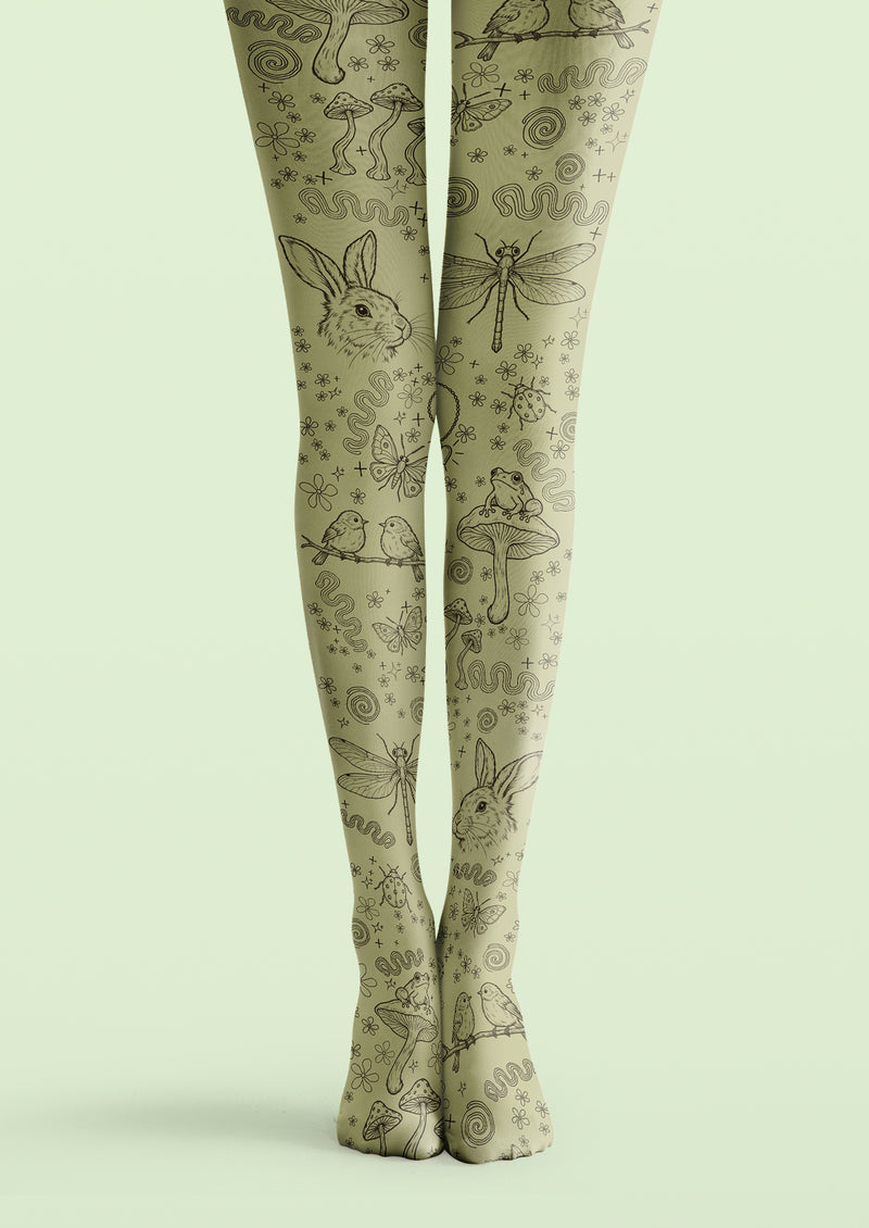 Green printed tights with black sketches of rabbits, mushrooms, frogs, birds, insects, small flowers, and spirals