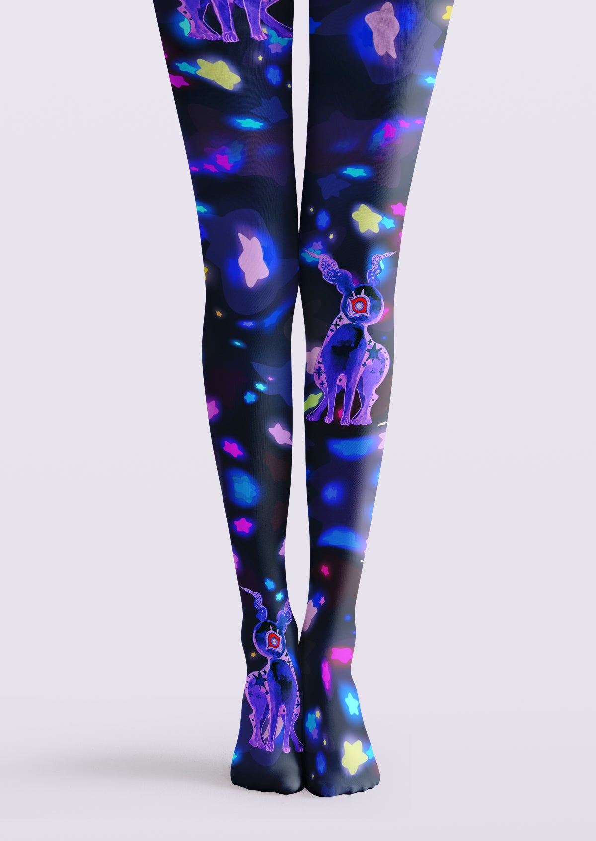 Black printed tights with purple one-eyed creatures and scattered colorful stars