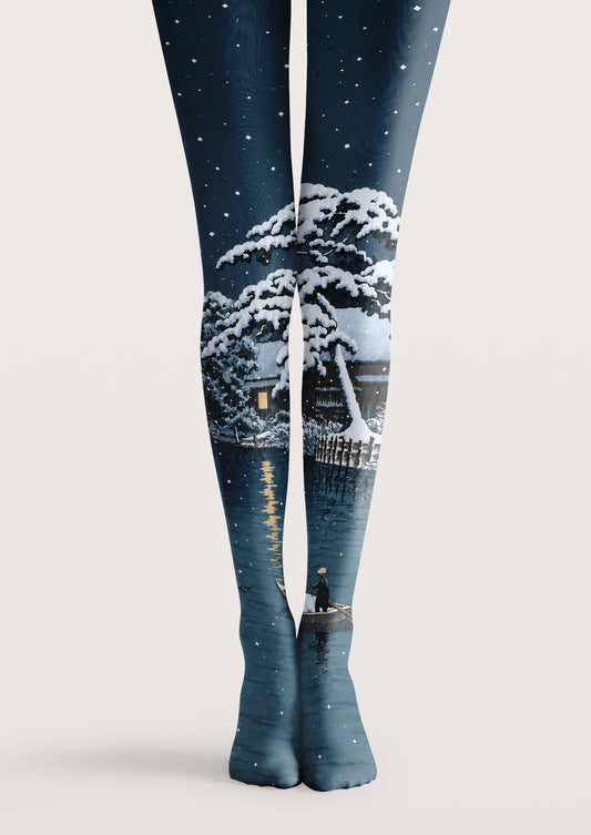 Navy printed tights with snowy winter landscape, trees, lake reflection, and falling snow details.