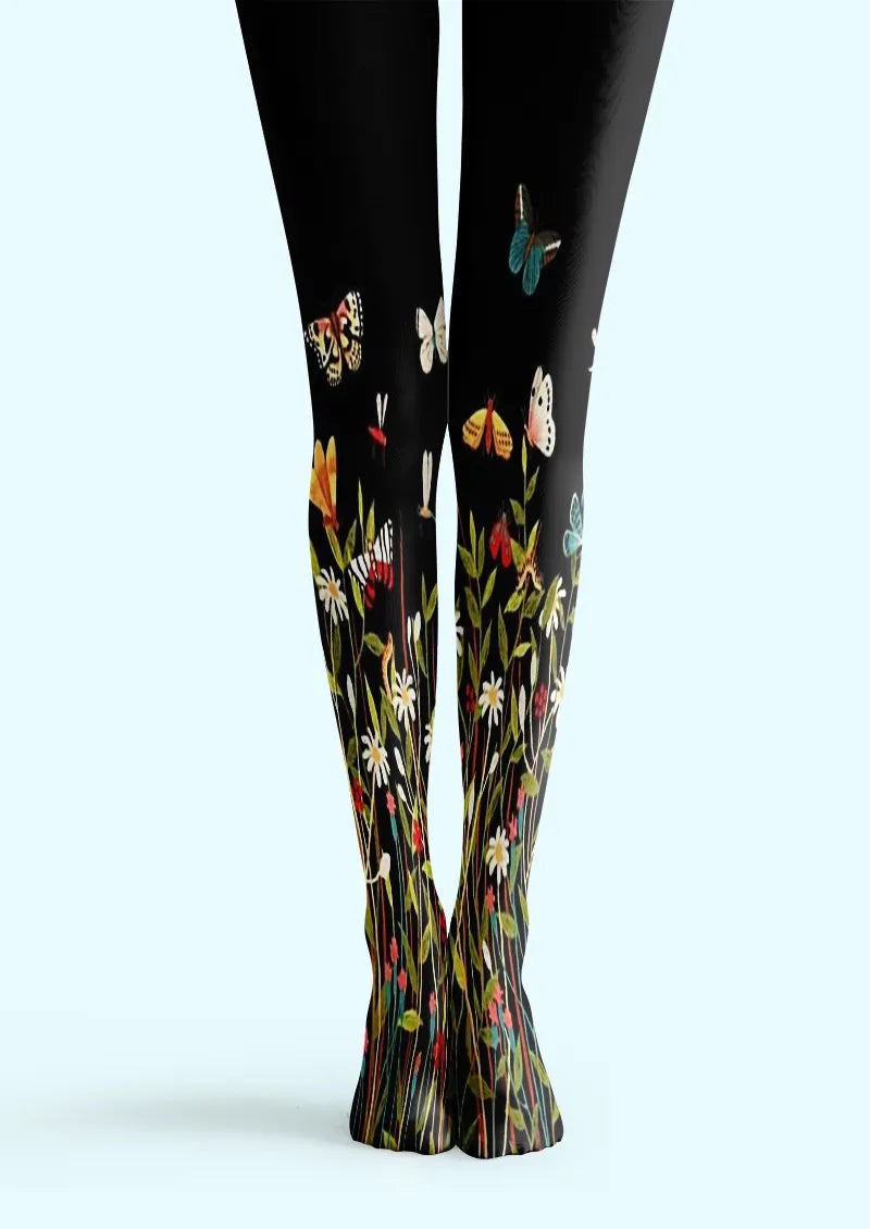 Black printed tights with wildflowers and colorful butterflies rising from the ankles