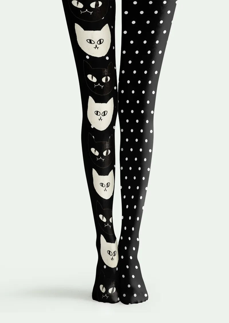 Black printed tights with alternating cat faces on one leg and white polka dots on the other.