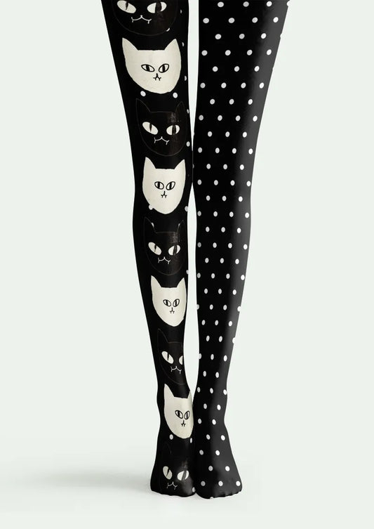 Black printed tights with alternating cat faces on one leg and white polka dots on the other.