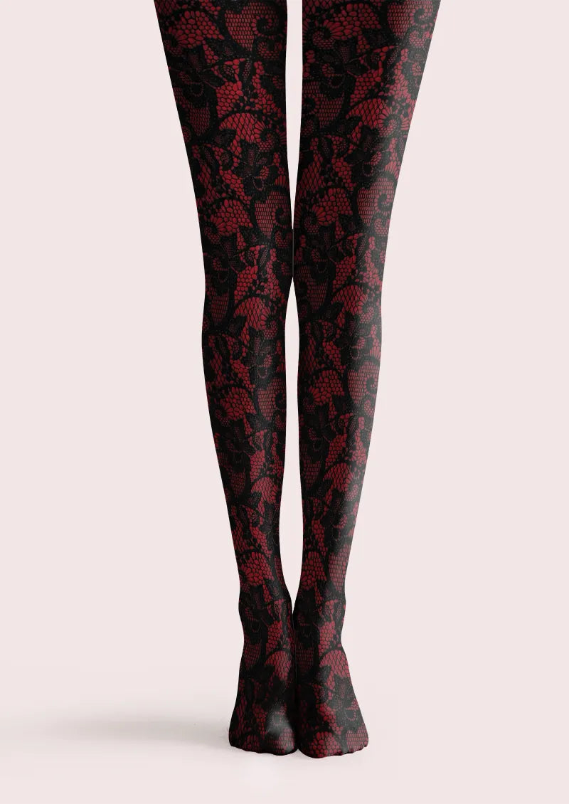 Burgundy printed tights with intricate black floral overlay motifs across both legs