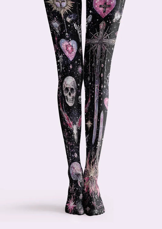Black printed tights with gray skulls, ornate crosses, pink hearts and star-like details on both legs.