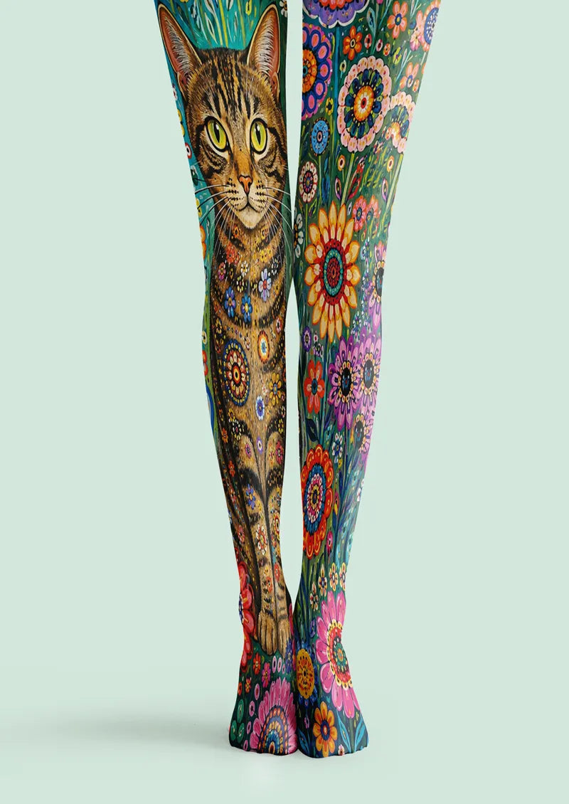 Green printed tights with an orange tabby cat and colorful floral motifs